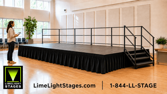 Multipurpose room featuring a LimeLight modular portable stage with black skirting, no-drill perimeter guardrails, and stage stairs with handrails.