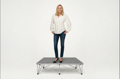LimeLight portable stage platform and riser combination with woman, 8 inches high, with gray carpet finish.