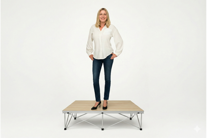 Woman standing on a LimeLight Lite Series 4x4 stage riser in Grey Carpet at 8" height. Ideal for schools, churches, and event professionals.