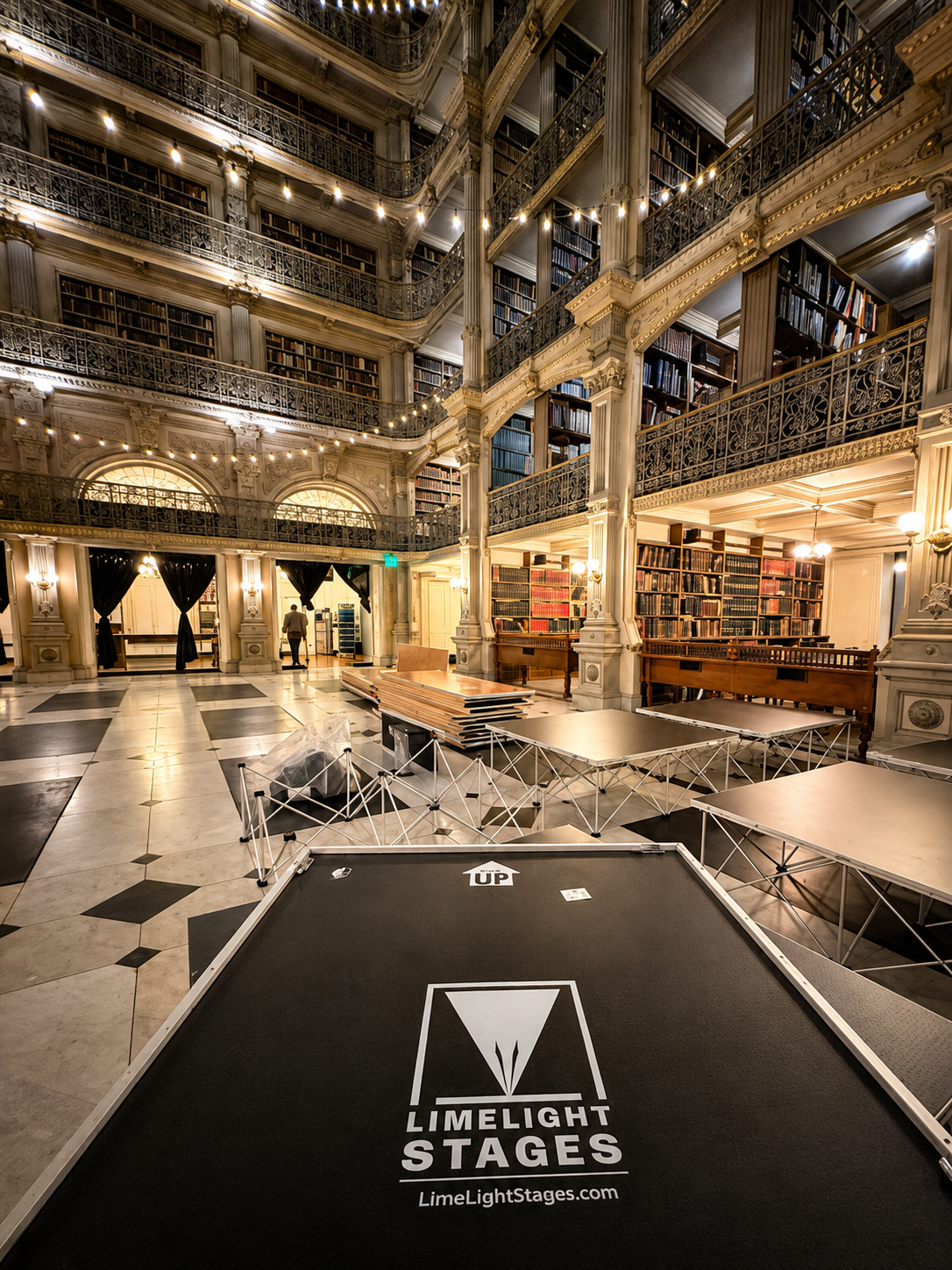 LimeLight Stages modular portable stage with platforms and expandable risers inside a historic library venue.