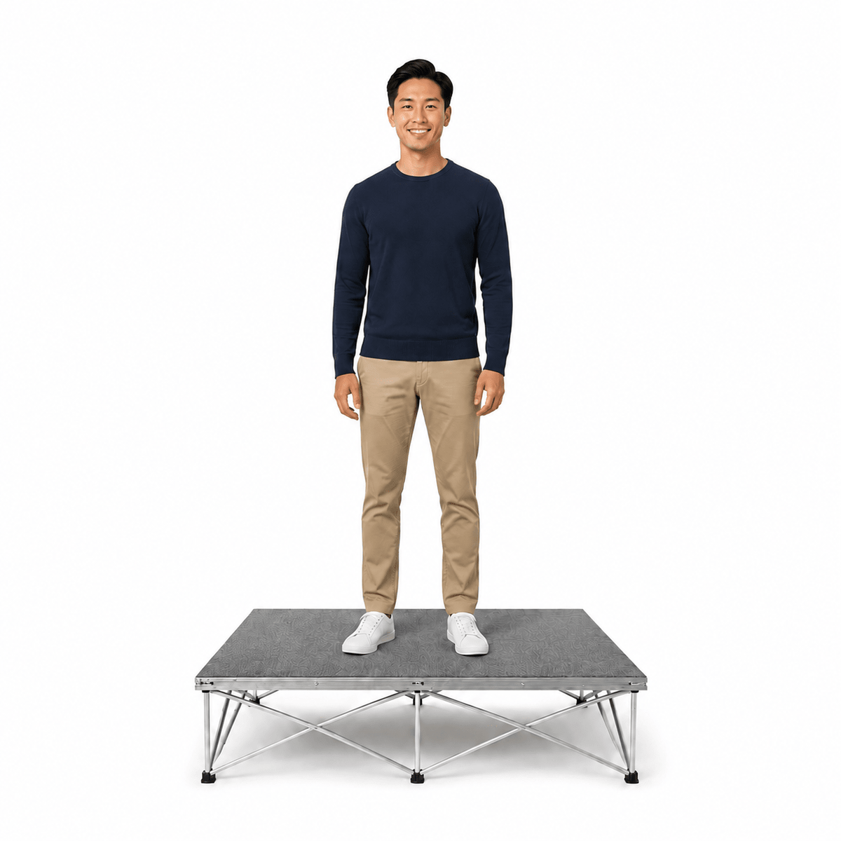 Man standing on a LimeLight modular portable stage with gray carpet finish.