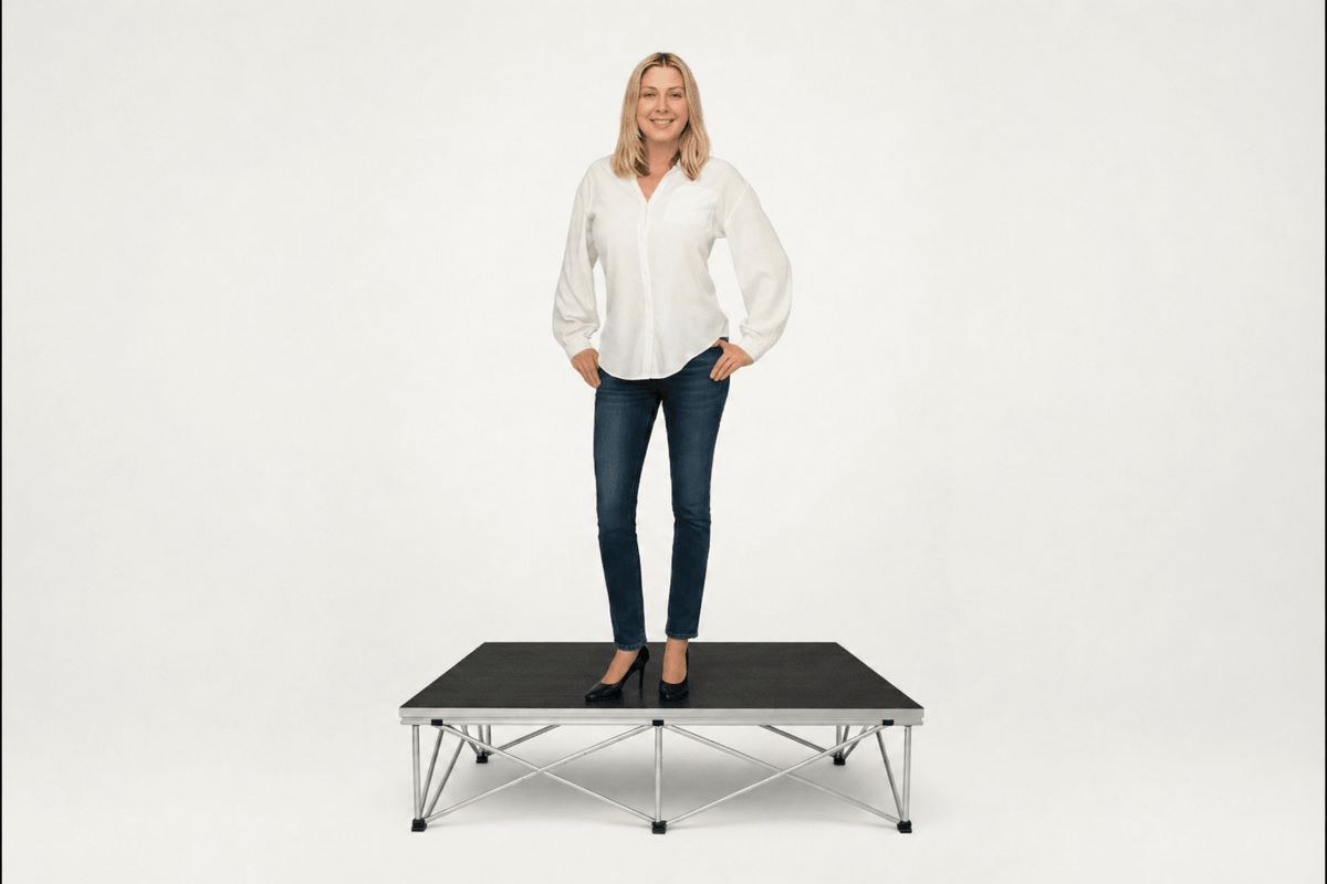 Woman standing on LimeLight portable stage platform and riser combination, 8 inches high, with black HexCoat finish.
