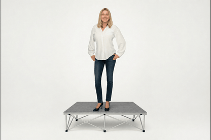 LimeLight portable stage platform and riser combination with woman, 8 inches high, with gray carpet finish.