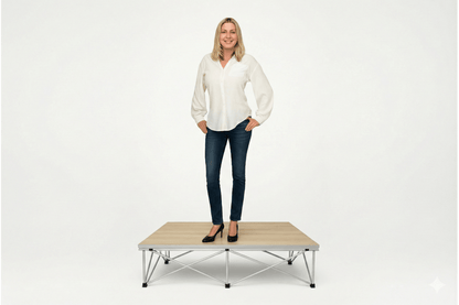 Woman standing on a LimeLight Lite Series 4x4 stage riser in Grey Carpet at 8" height. Ideal for schools, churches, and event professionals.
